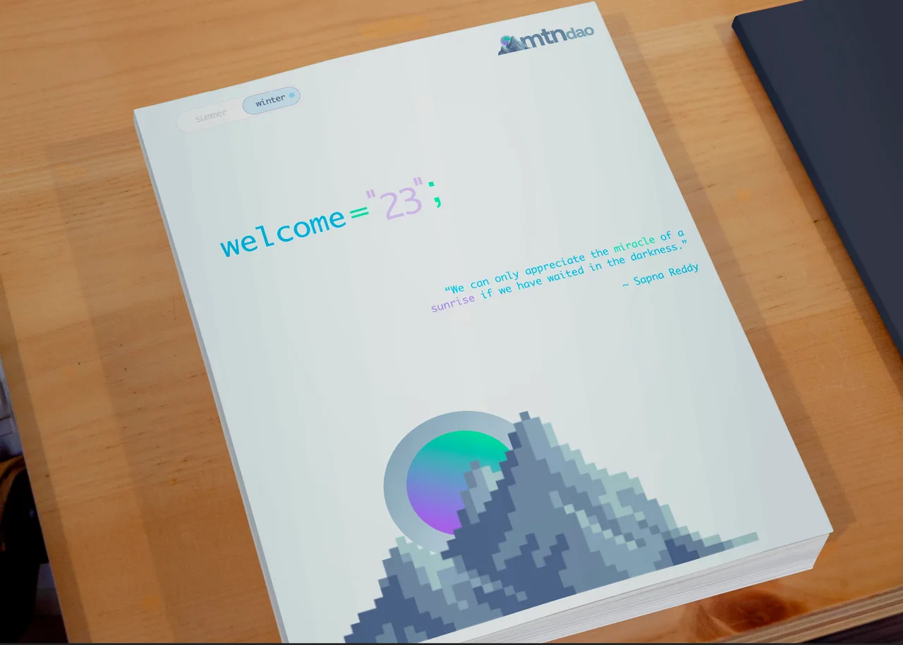 mtndao winter welcome book with pixel mountain artwork on a wooden table